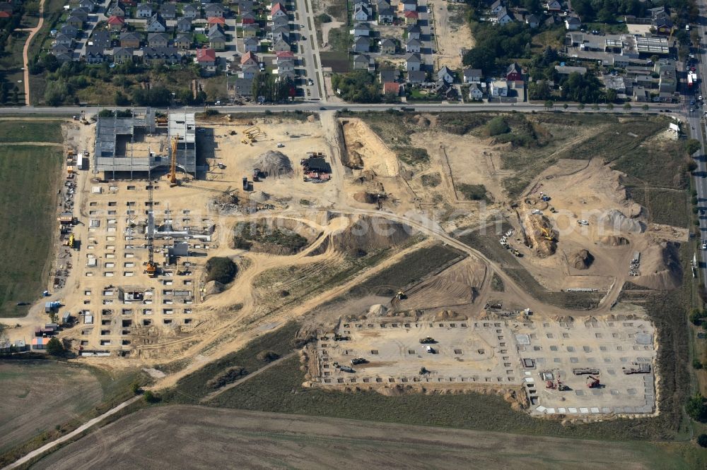 Berlin from the bird's eye view: Construction site for the new building home-center of the Porta-Group at Pilgramer street in the district Mahlsdorf in Berlin