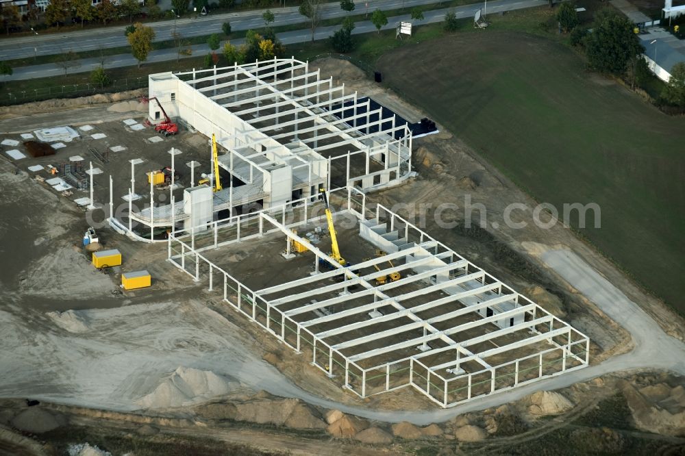 Berlin from the bird's eye view: Construction site for the new building home-center of the Porta-Group at Pilgramer street in the district Mahlsdorf in Berlin