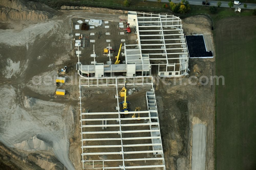 Berlin from the bird's eye view: Construction site for the new building home-center of the Porta-Group at Pilgramer street in the district Mahlsdorf in Berlin