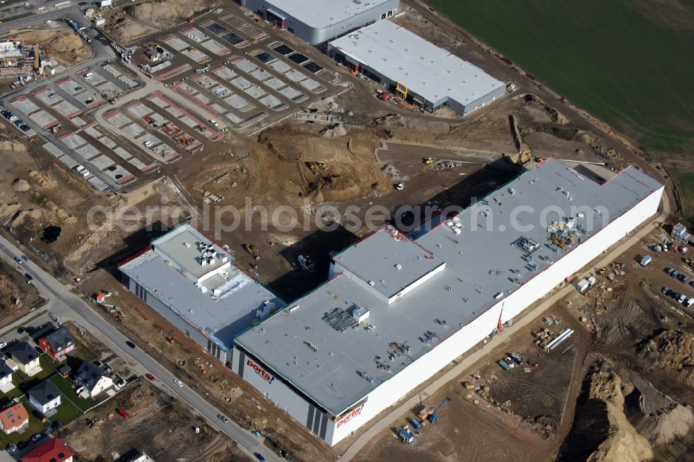 Berlin from the bird's eye view: Construction site for the new building home-center of the Porta-Group at Pilgramer street in the district Mahlsdorf in Berlin