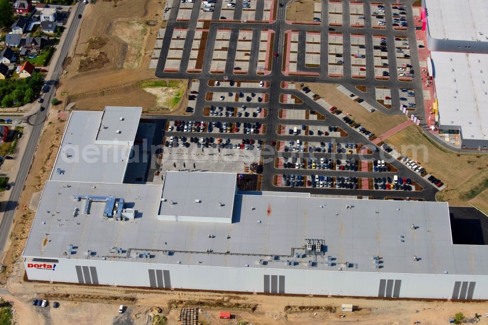 Aerial photograph Berlin - Construction site for the new building home-center of the Porta-Group at Pilgramer street in the district Mahlsdorf in Berlin