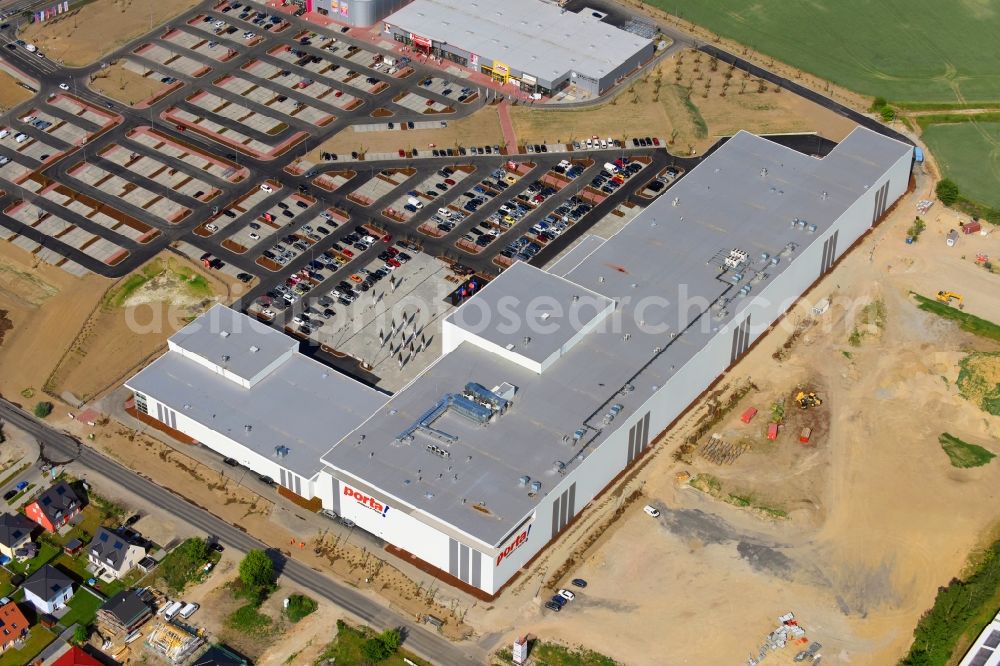 Berlin from the bird's eye view: Construction site for the new building home-center of the Porta-Group at Pilgramer street in the district Mahlsdorf in Berlin