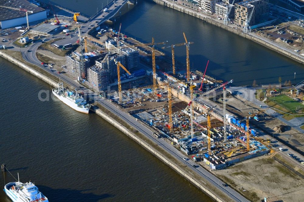 Hamburg from the bird's eye view: Construction site to build a new multi-family residential complex on Baakenallee in the district HafenCity in Hamburg, Germany