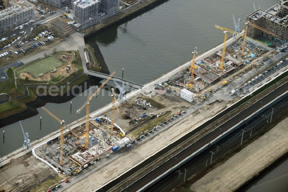 Hamburg from the bird's eye view: Construction site to build a new multi-family residential complex on Baakenallee in the district HafenCity in Hamburg, Germany