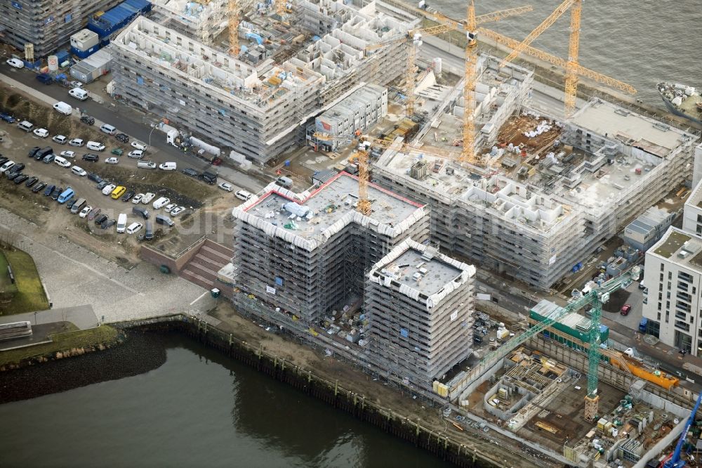 Hamburg from the bird's eye view: Construction site to build a new multi-family residential complex on Baakenallee in the district HafenCity in Hamburg, Germany