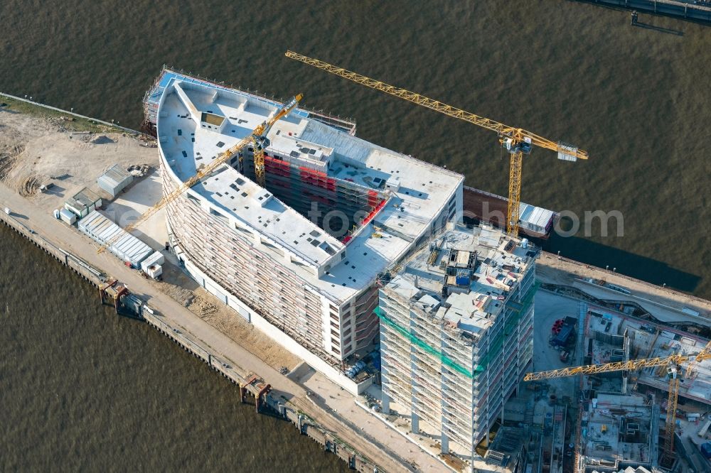 Hamburg from the bird's eye view: Construction site to build a new multi-family residential complex of DC DEVELOPMENTS GMBH & CO. KG on Strandkai in the district HafenCity in Hamburg, Germany