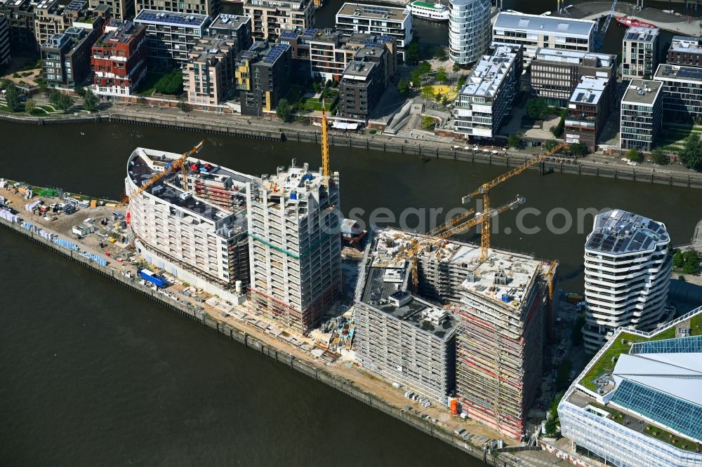 Hamburg from the bird's eye view: Construction site to build a new multi-family residential complex of DC DEVELOPMENTS GMBH & CO. KG on Strandkai in the district HafenCity in Hamburg, Germany