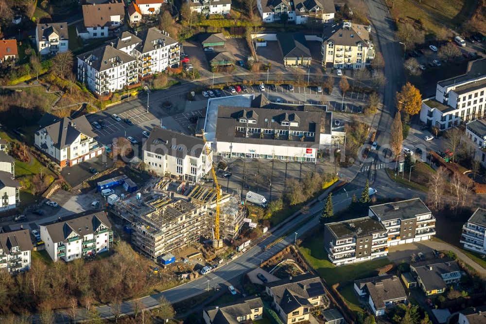 Aerial photograph Finnentrop - Construction site to build a new multi-family residential complex of Sparkasse Finnentrop on Serkenroof Strasse in Finnentrop in the state North Rhine-Westphalia, Germany