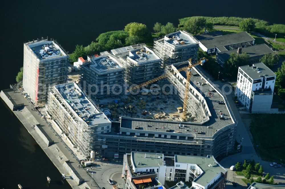 Rostock from the bird's eye view: Construction site to build a new multi-family residential complex Inselquartier on Gaffelschonerweg - Loggerweg in Rostock in the state Mecklenburg - Western Pomerania, Germany