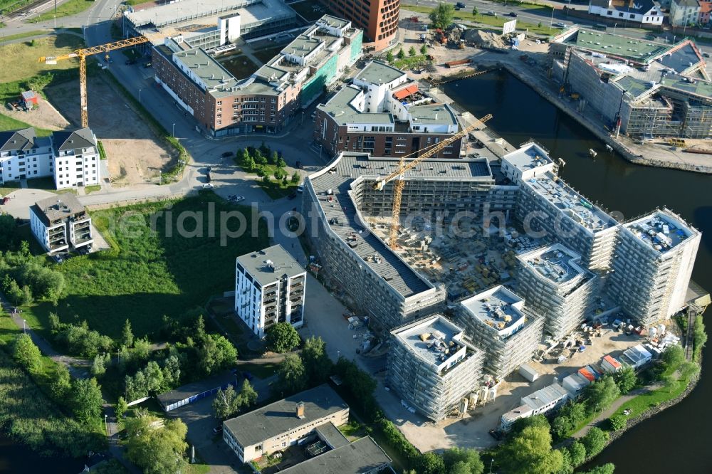 Rostock from the bird's eye view: Construction site to build a new multi-family residential complex Inselquartier on Gaffelschonerweg - Loggerweg in Rostock in the state Mecklenburg - Western Pomerania, Germany