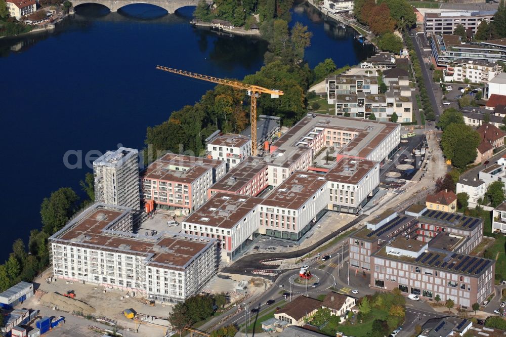 Rheinfelden from the bird's eye view: Construction site for building a new multi-family residential complex Salmen Park on a former brewery site in Rheinfelden in Switzerland at the river Rhine