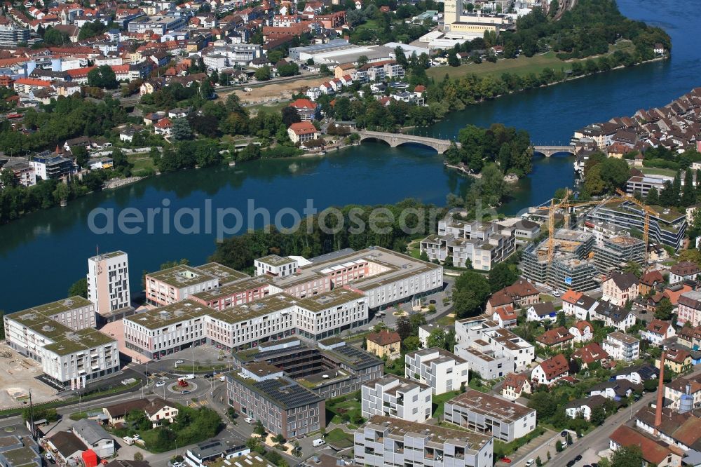 Rheinfelden from the bird's eye view: Construction site for building a new multi-family residential complex Salmen Park on a former brewery site in Rheinfelden in Switzerland at the river Rhine