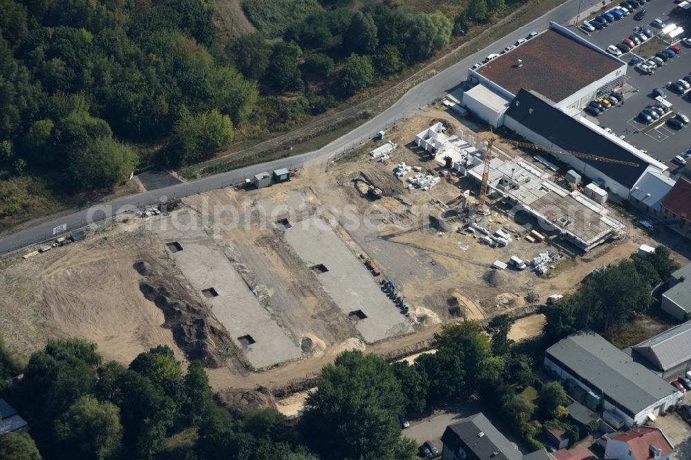 Berlin from the bird's eye view: Construction site to build a new multi-family residential complex An der Schule destrict Mahlsdorf in Berlin