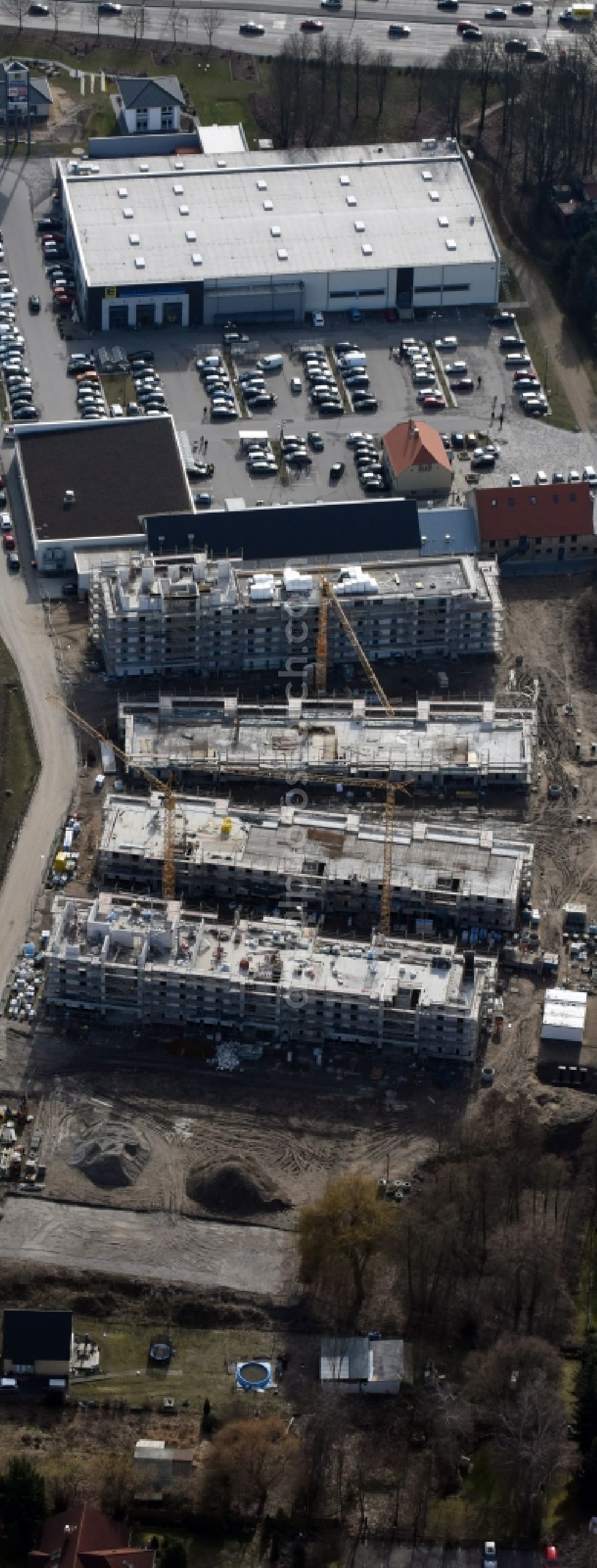 Berlin from the bird's eye view: Construction site to build a new multi-family residential complex An der Schule destrict Mahlsdorf in Berlin