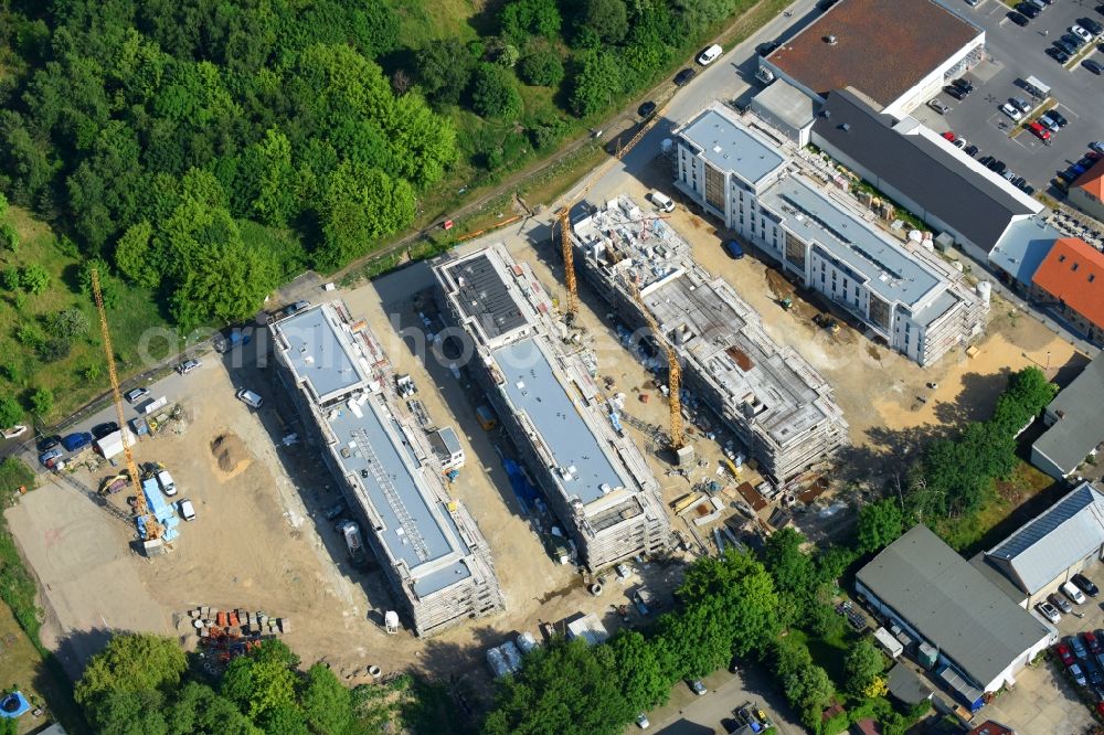 Berlin from the bird's eye view: Construction site to build a new multi-family residential complex An der Schule destrict Mahlsdorf in Berlin