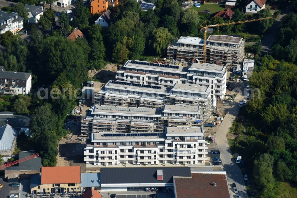 Berlin from the bird's eye view: Construction site to build a new multi-family residential complex An der Schule destrict Mahlsdorf in Berlin