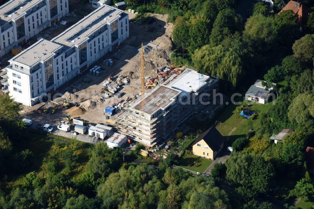 Berlin from the bird's eye view: Construction site to build a new multi-family residential complex An der Schule destrict Mahlsdorf in Berlin