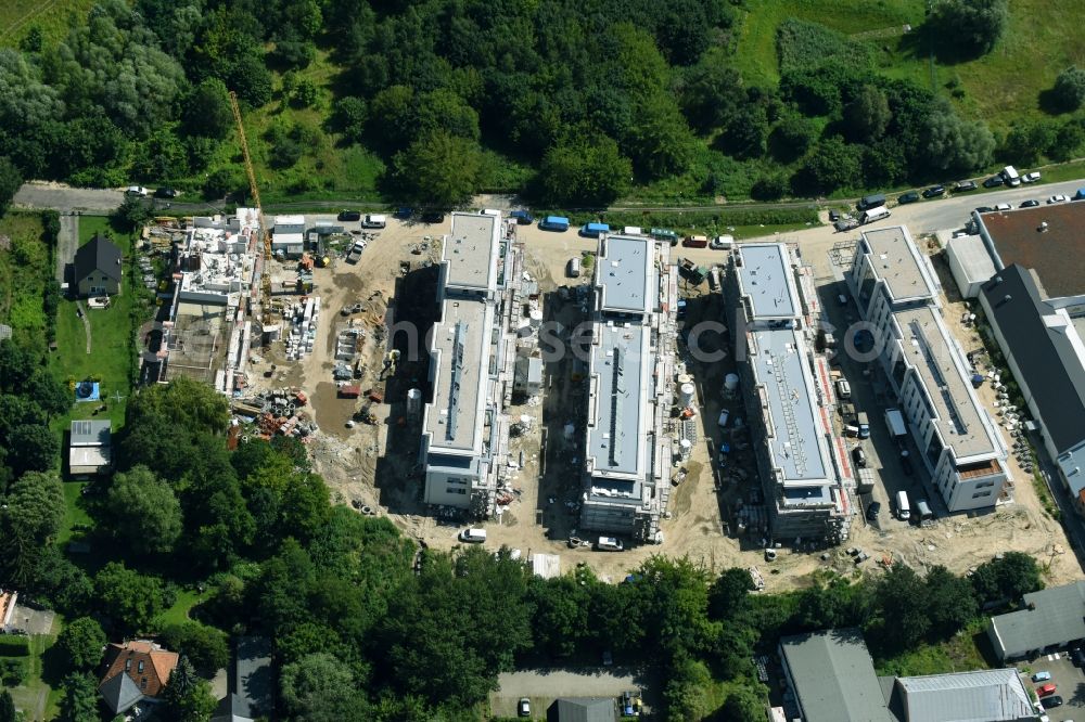 Berlin from the bird's eye view: Construction site to build a new multi-family residential complex An der Schule destrict Mahlsdorf in Berlin