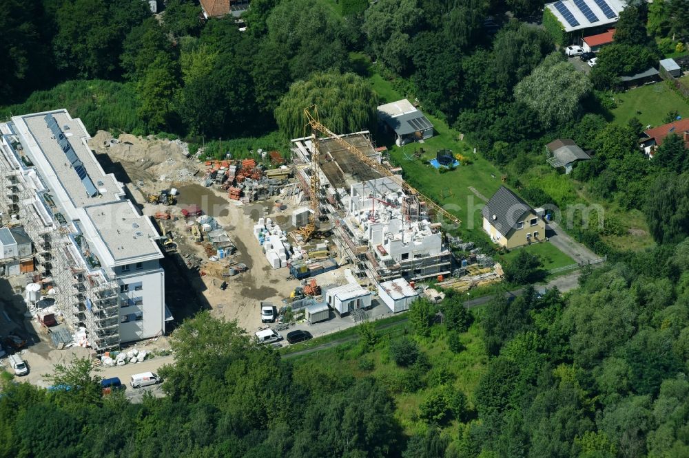 Berlin from the bird's eye view: Construction site to build a new multi-family residential complex An der Schule destrict Mahlsdorf in Berlin