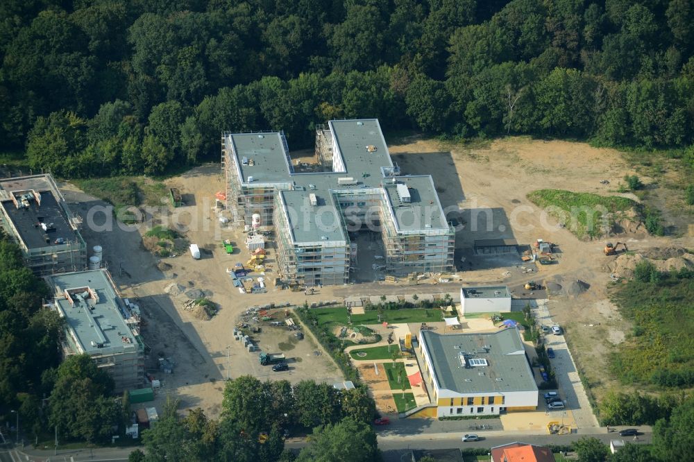 Leipzig from the bird's eye view: Construction site for the new building of a multi-generational project in Leipzig in the state of Saxony. The compound includes the finished child day care facility, a sports school, an elderly care home. It is located on Goyastrasse