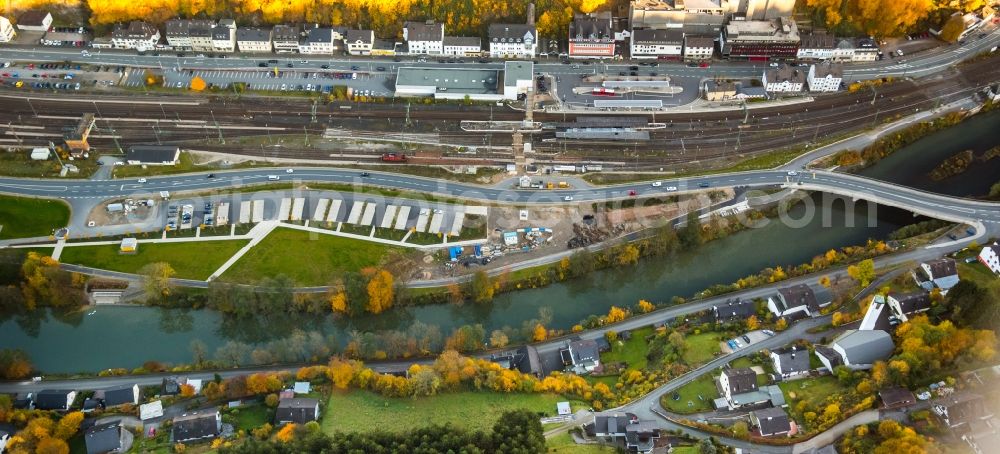 Aerial image Finnentrop - Construction site for the new bus station and train station of the autumnal Finnentrop in the state of North Rhine-Westphalia. The station is located on the riverbank of the river Lenne