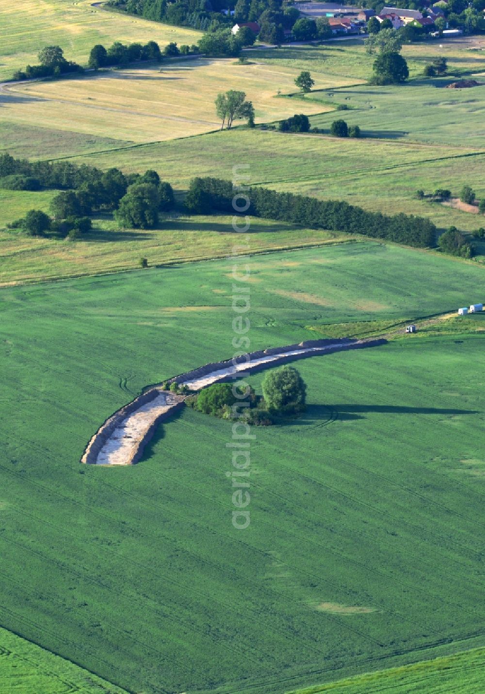 Werneuchen from the bird's eye view: Construction site for the new building a bypass road through a field in Weesower Luch in Werneuchen in the state Brandenburg