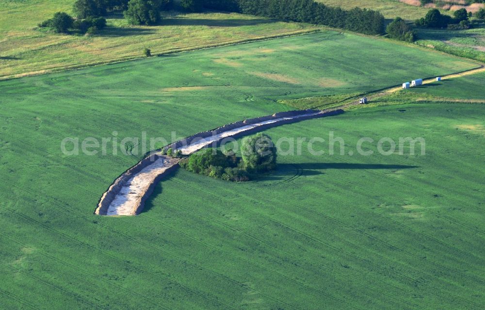 Aerial photograph Werneuchen - Construction site for the new building a bypass road through a field in Weesower Luch in Werneuchen in the state Brandenburg