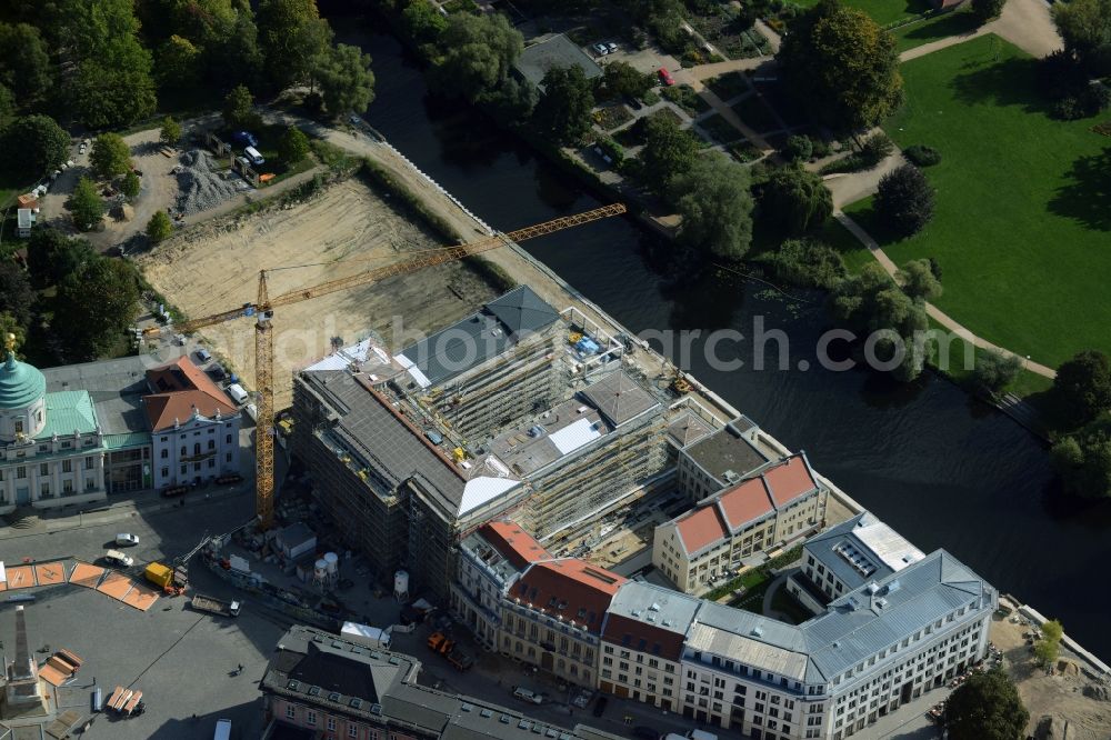 Potsdam from the bird's eye view: Construction site for the new building of the quarter HQ Humboldt in Potsdam in the state of Brandenburg. The Humboldt quarter is located on the riverbank of the Alte Fahrt and will include offices and residential apartments