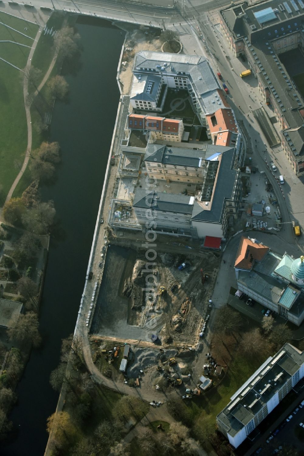 Potsdam from the bird's eye view: Construction site for the new building of the quarter HQ Humboldt in Potsdam in the state of Brandenburg. The Humboldt quarter is located on the riverbank of the Alte Fahrt and will include offices and residential apartments