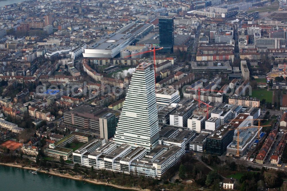 Aerial photograph Basel - Constructionprogress on Roche Tower on the premises of the pharmaceutical company Hoffmann-La Roche AG, Basel, Switzerland. The overall height of the building of 178 meters is reached. Thus, the Roche Tower is the tallest building in Switzerland. Upon completion in 2015, planned by the Basel architects Herzog & de Meuron, the building will be the headquarters of Hoffmann-La Roche AG