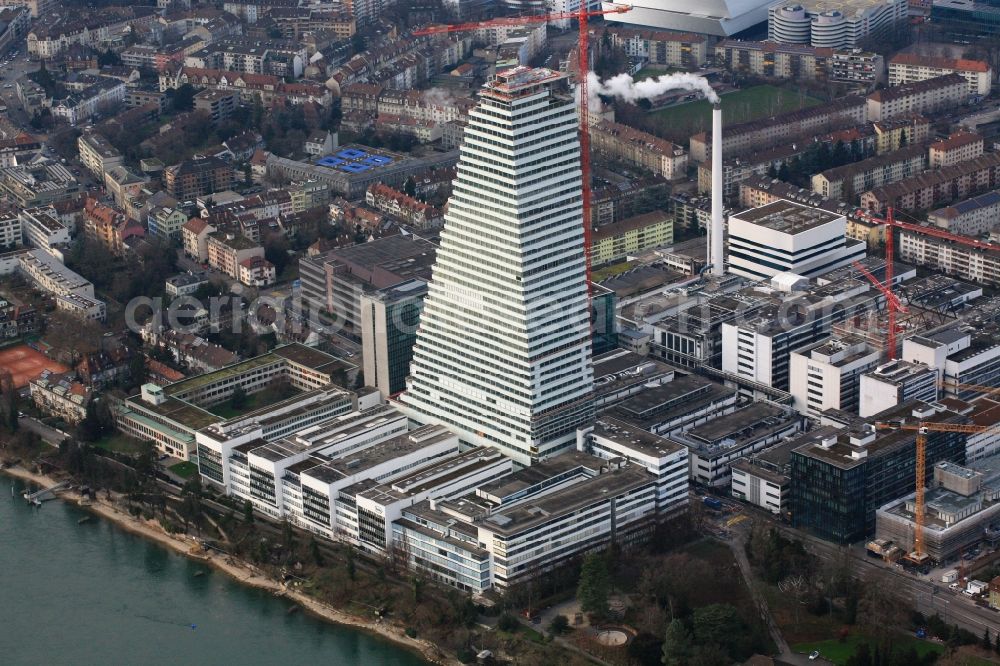 Basel from above - Constructionprogress on Roche Tower on the premises of the pharmaceutical company Hoffmann-La Roche AG, Basel, Switzerland. The overall height of the building of 178 meters is reached. Thus, the Roche Tower is the tallest building in Switzerland. Upon completion in 2015, planned by the Basel architects Herzog & de Meuron, the building will be the headquarters of Hoffmann-La Roche AG