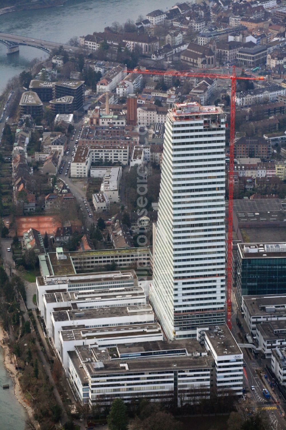 Aerial image Basel - Constructionprogress on Roche Tower on the premises of the pharmaceutical company Hoffmann-La Roche AG, Basel, Switzerland. The overall height of the building of 178 meters is reached. Thus, the Roche Tower is the tallest building in Switzerland. Upon completion in 2015, planned by the Basel architects Herzog & de Meuron, the building will be the headquarters of Hoffmann-La Roche AG