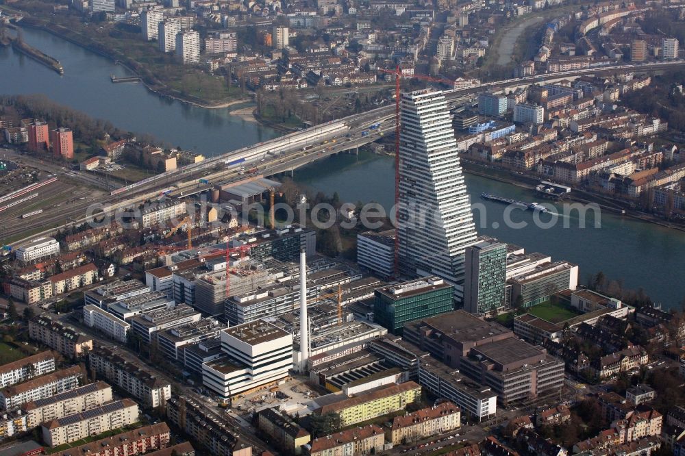 Basel from the bird's eye view: Constructionprogress on Roche Tower on the premises of the pharmaceutical company Hoffmann-La Roche AG, Basel, Switzerland. The overall height of the building of 178 meters is reached. Thus, the Roche Tower is the tallest building in Switzerland. Upon completion in 2015, planned by the Basel architects Herzog & de Meuron, the building will be the headquarters of Hoffmann-La Roche AG