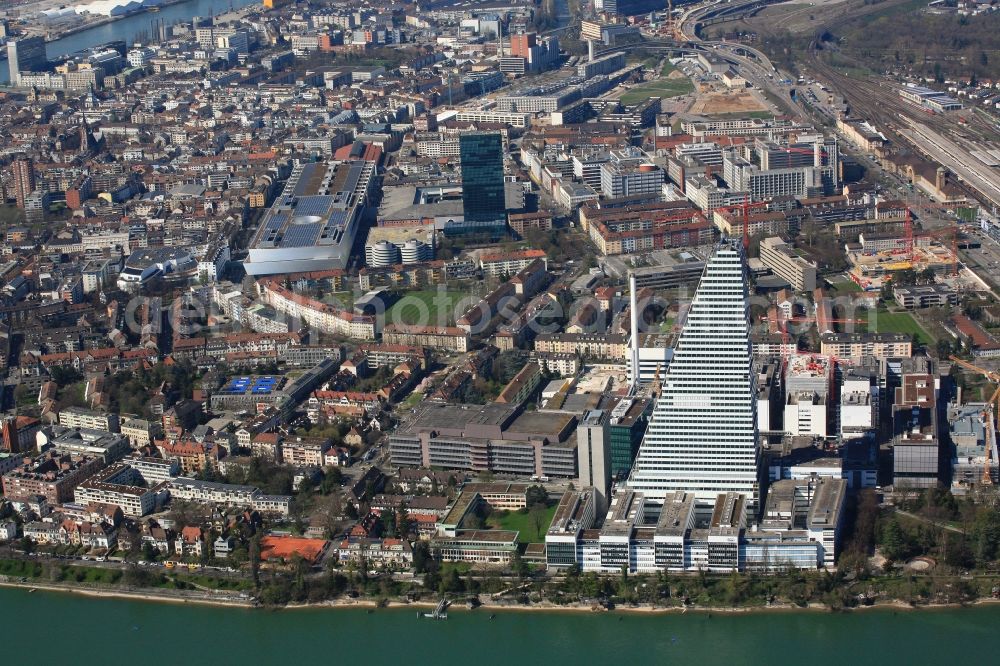 Aerial photograph Basel - Constructionprogress on Roche Tower on the premises of the pharmaceutical company Hoffmann-La Roche AG, Basel, Switzerland. The overall height of the building of 178 meters is reached. Thus, the Roche Tower is the tallest building in Switzerland. Upon completion in 2015, planned by the Basel architects Herzog & de Meuron, the building will be the headquarters of Hoffmann-La Roche AG