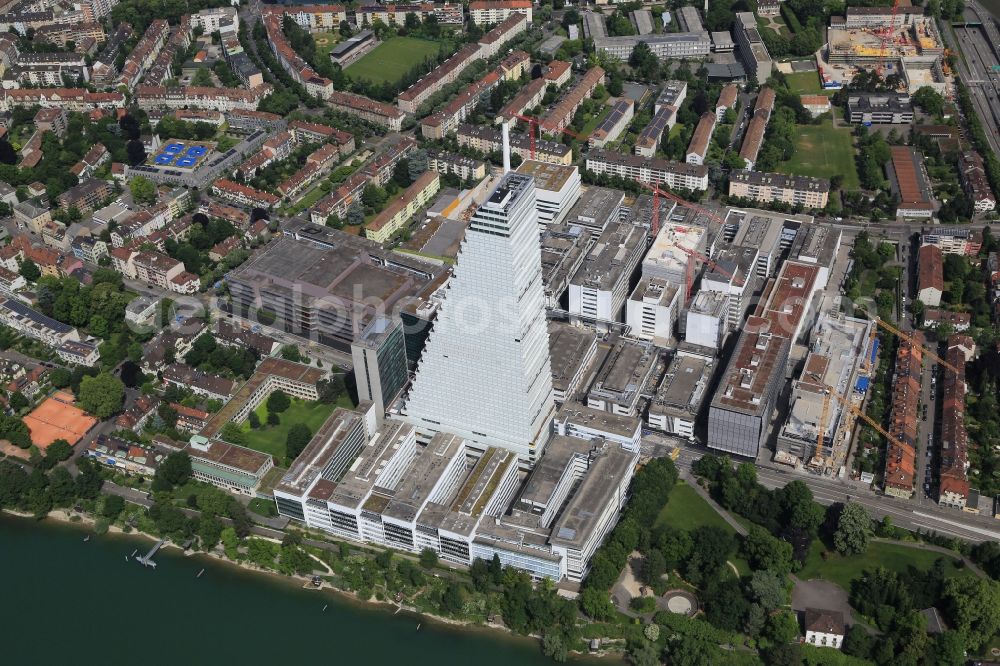 Basel from the bird's eye view: Constructionprogress on Roche Tower on the premises of the pharmaceutical company Hoffmann-La Roche AG, Basel, Switzerland. The overall height of the building of 178 meters is reached. Thus, the Roche Tower is the tallest building in Switzerland. Upon completion in 2015, planned by the Basel architects Herzog & de Meuron, the building will be the headquarters of Hoffmann-La Roche AG