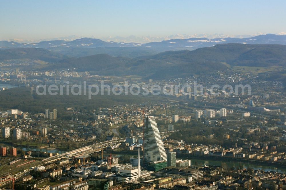 Basel from the bird's eye view: Constructionprogress on Roche Tower on the premises of the pharmaceutical company Hoffmann-La Roche AG, Basel, Switzerland. The overall height of the building of 178 meters is reached. Thus, the Roche Tower is the tallest building in Switzerland. Upon completion in 2015, planned by the Basel architects Herzog & de Meuron, the building will be the headquarters of Hoffmann-La Roche AG