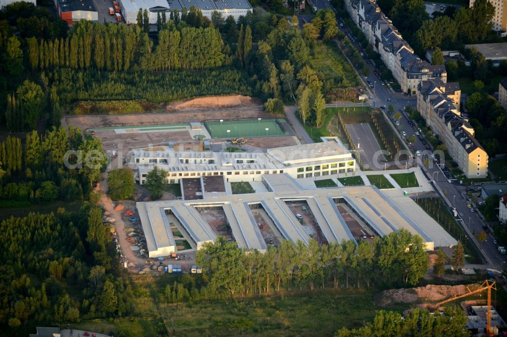 Aerial photograph Chemnitz - Construction site for the new building of a center for special needs education KOE in Chemnitz in the state of Saxony. The building complex on Heinrich-Schuetz-Strasse was designed by Daehne Architects