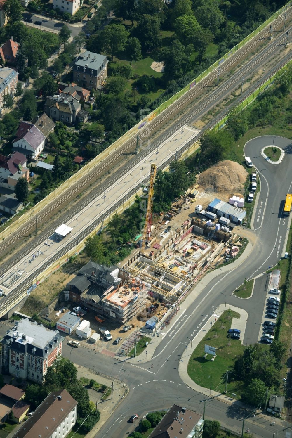 Aerial image Markkleeberg - Construction site for the new building of an indoor pool and renovation of the train station building of Markkleeberg in the state of Saxony. The historic station building is being renovated