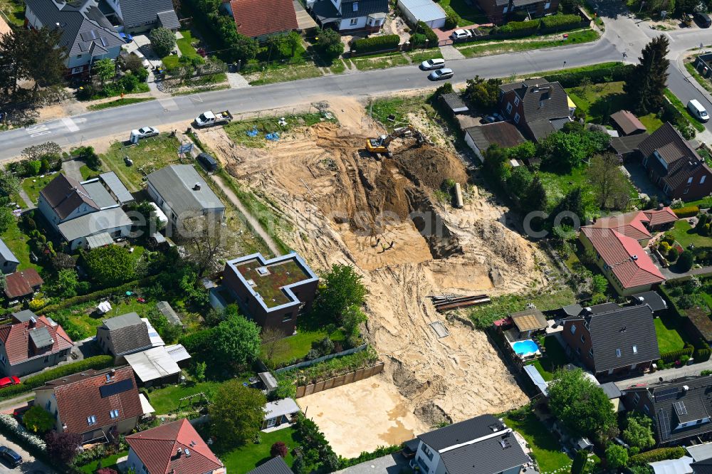 Berlin from above - Construction site for the new construction of a multi-family residential building as a townhouse on street Neuenhagener Strasse in the district Mahlsdorf in Berlin, Germany