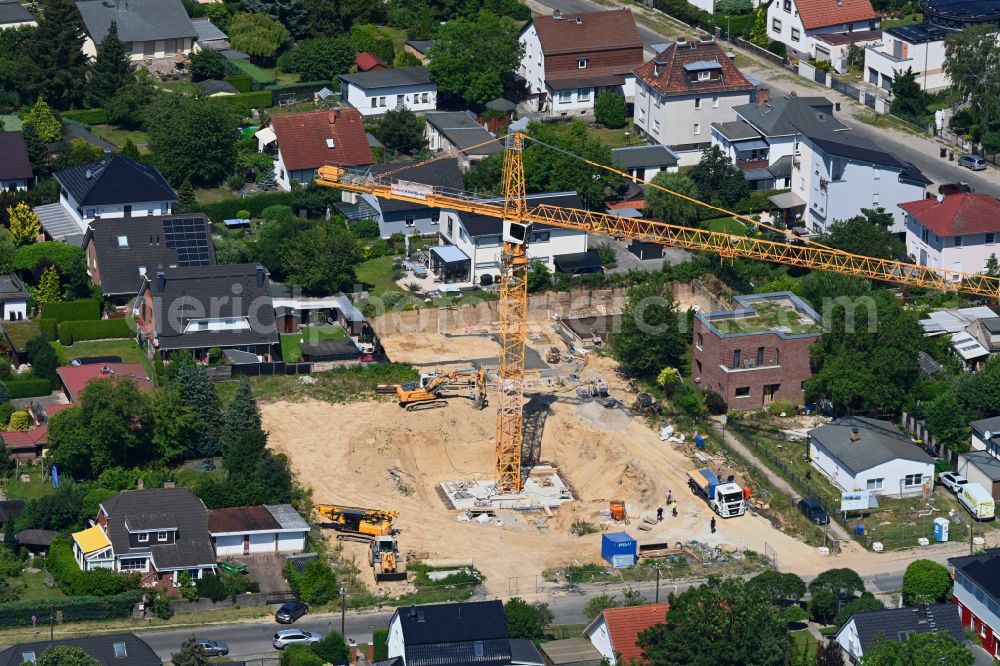 Berlin from the bird's eye view: Construction site for the new construction of a multi-family residential building as a townhouse on street Neuenhagener Strasse in the district Mahlsdorf in Berlin, Germany