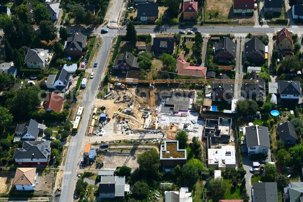 Aerial photograph Berlin - Construction site for the new construction of a multi-family residential building as a townhouse on street Neuenhagener Strasse in the district Mahlsdorf in Berlin, Germany