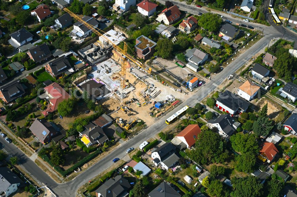 Berlin from above - Construction site for the new construction of a multi-family residential building as a townhouse on street Neuenhagener Strasse in the district Mahlsdorf in Berlin, Germany