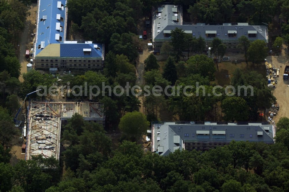 Aerial photograph Berlin - Construction site for the new building of residential buildings on the compound of the former children's home Makarenko in the Johannisthal part of Berlin in Germany. The compound with different buildings is located in the forest area of Koenigsheide. A new residential estate is being built