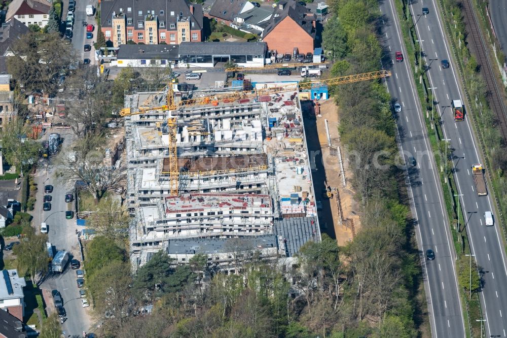 Hamburg from the bird's eye view: Construction site for the construction of a multi-family residential and commercial building ensemble on the Alte Suelldorfer Landstrasse in the Rissen district in Hamburg, Germany