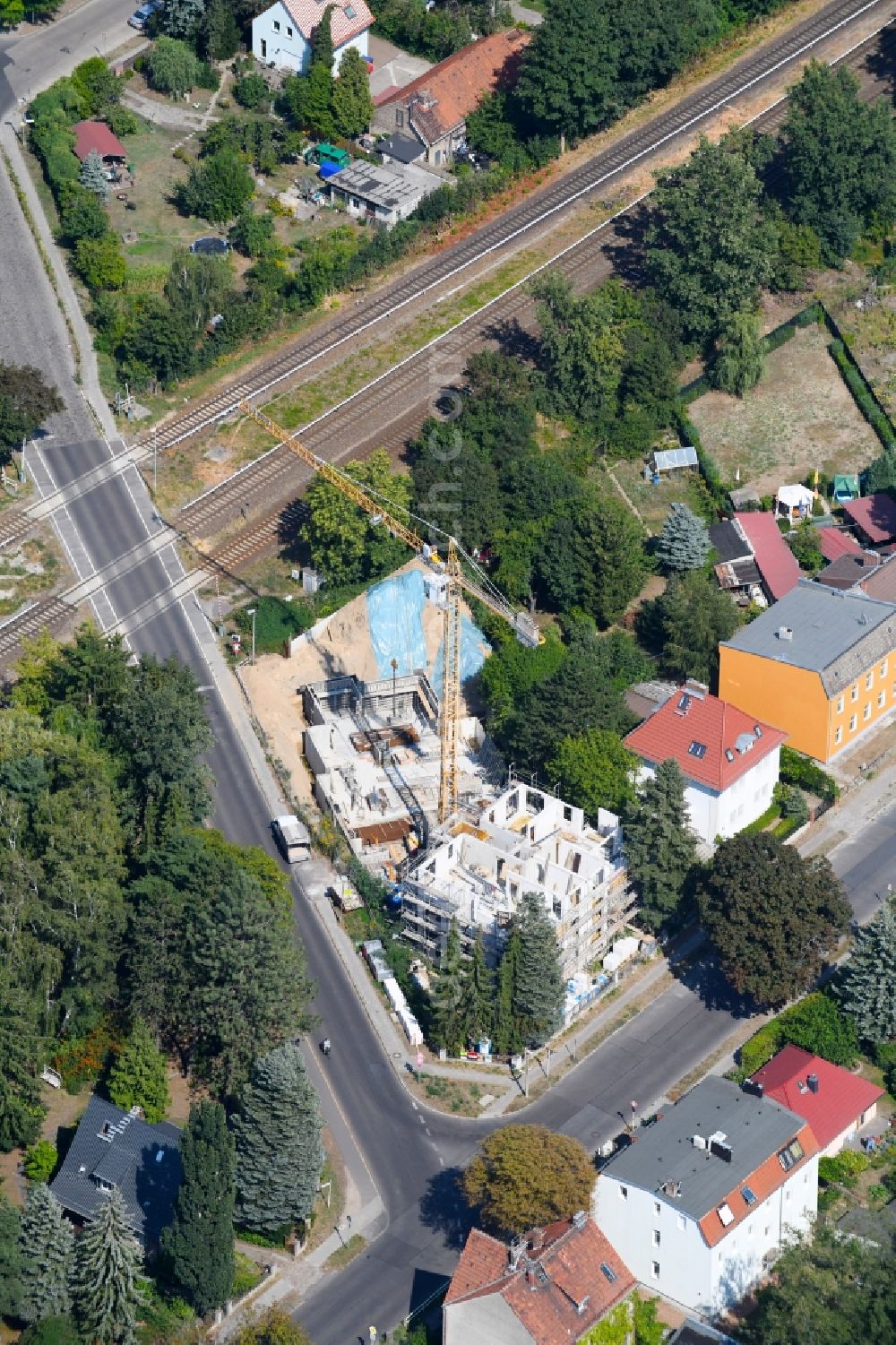 Berlin from the bird's eye view: Construction site for the new residential and commercial building on the on Lemkestrasse corner Donizettistrasse in the district Mahlsdorf in Berlin, Germany