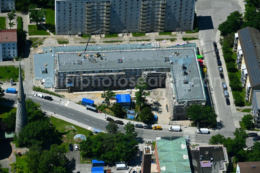 München from the bird's eye view: Construction site for the new residential and commercial building am Stanigplatz in front of church St. Nikolaus in the district Hasenbergl in Munich in the state Bavaria, Germany