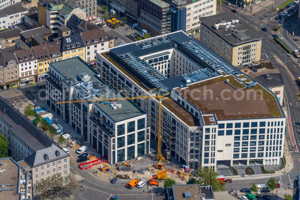 Mülheim an der Ruhr from the bird's eye view: Construction site for the new building eines Wohn- and Geschaeftshausviertels on Schlossstrasse - Schollenstrasse - Friedrich-Ebert-Allee in Muelheim on the Ruhr in the state North Rhine-Westphalia