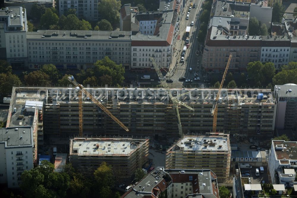 Berlin from above - View on the building site for construction of a residential house and commercial building supervised by the DIW Bau GmbH at the Warschauer Strasse near Frankfurter Tor in Berlin in Germany