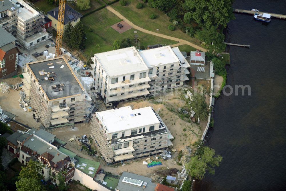 Aerial photograph Berlin - Construction site for the new building of an appartment building complex on the seafront of Mueggelsee in the Friedrichshagen part of Berlin in Germany. The compound includes three residential buildings. The building project and construction site is located right on the shores of the lake