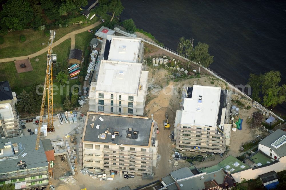 Berlin from the bird's eye view: Construction site for the new building of an appartment building complex on the seafront of Mueggelsee in the Friedrichshagen part of Berlin in Germany. The compound includes three residential buildings. The building project and construction site is located right on the shores of the lake